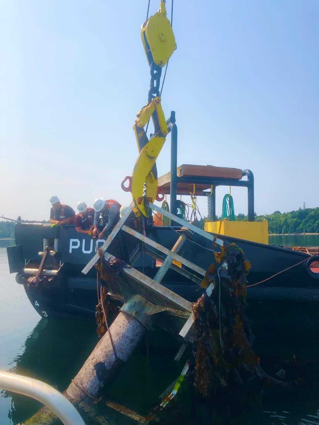 Debris recovery vessel recovers a navigational aid out of the Nisqually Flats, DuPont, Washington.