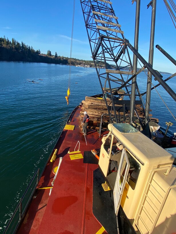 Recovery debris vessel snags and removes logs near Whidbey Island, Washington.