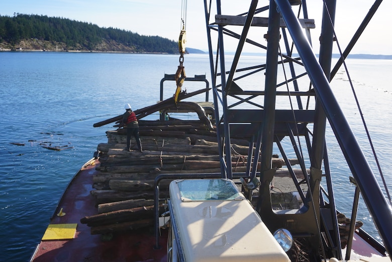 Debris recovery vessel recovering a navigational aid in Nisqually Flats, DuPoint, Washington.