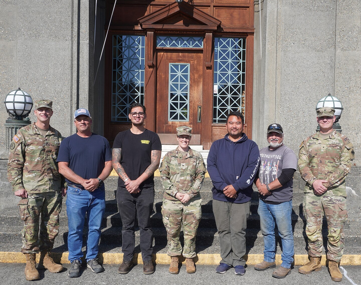 Group photo of Army officers and civilians standing in front of the Administration building of the Lake Washington Ship Canal and Hiram M. Chittenden Locks, Seattle, Washington.