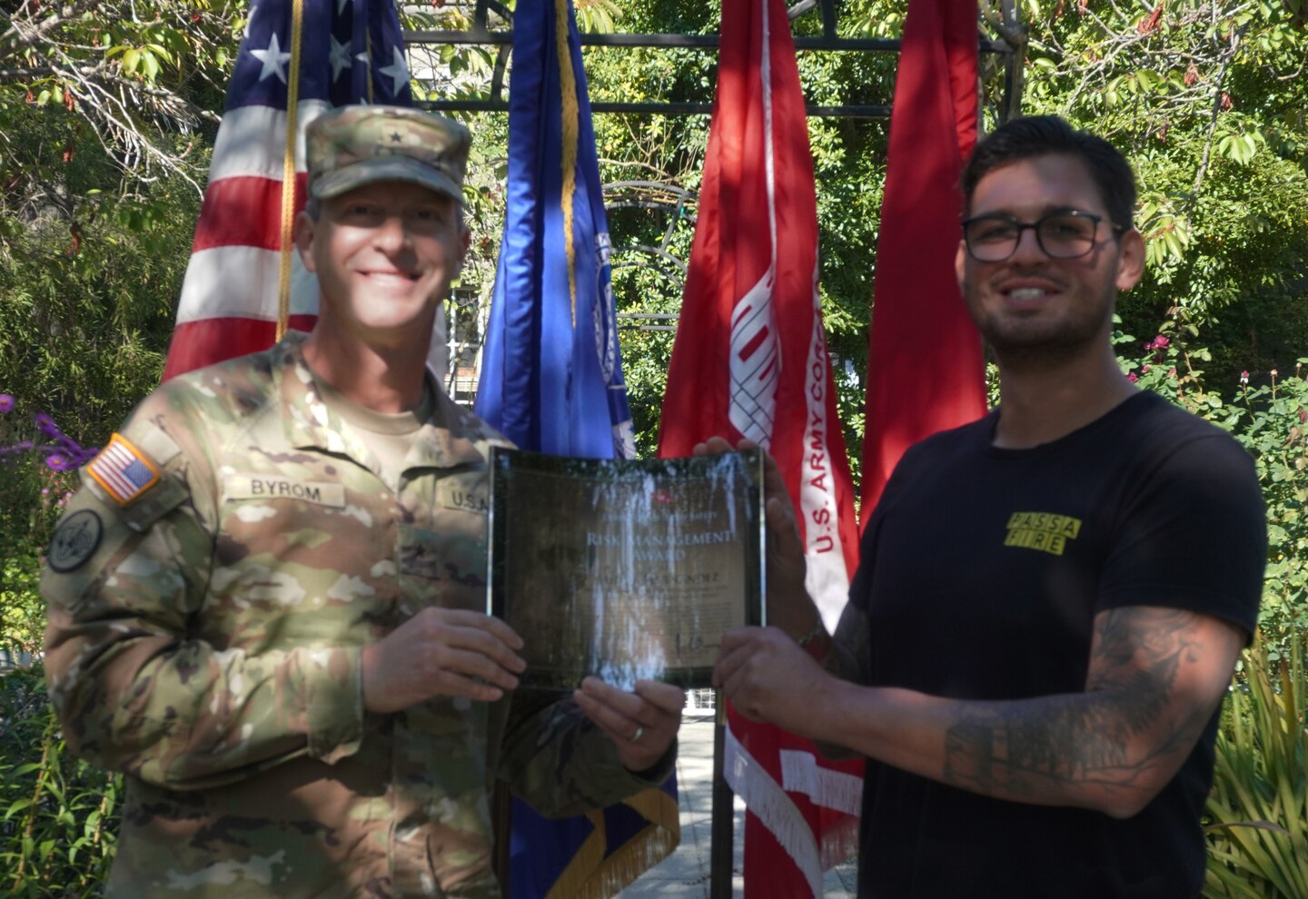 An Army officer presents an award to a civilian in the rose garden of the Lake Washington Ship Canal and Hiram M. Chittenden Locks, Seattle, Washington