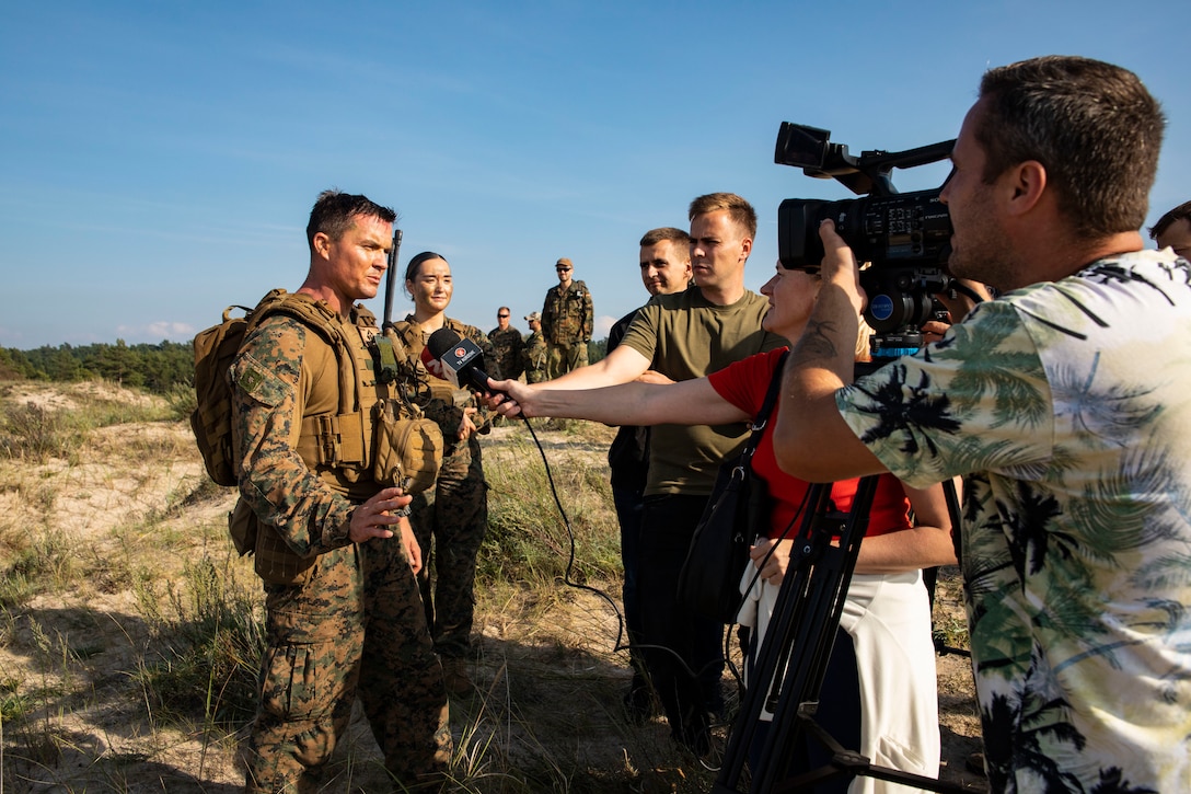 U.S. Marine Corps Maj. Adam White, company commander, Charlie Company, Battalion Landing Team 1/6, 26th Marine Expeditionary Unit (Special Operations Capable) (26MEU(SOC)), speaks to media during an amphibious landing for Northern Coast 2023 (NOCO 23) in Ventspils, Latvia, Sept. 12, 2023. NOCO 23 is a German-led multinational exercise that strengthens military and maritime combat readiness through realistic training in order to sharpen interoperability with our Allies and partners. The San Antonio-class amphibious ship USS Mesa Verde (LPD 19), assigned to the Bataan Amphibious Ready Group and embarked 26MEU(SOC), under the command and control of Task Force 61/2, is on a scheduled deployment in the U.S. Naval Forces Europe area of operations, employed by U.S. Sixth Fleet to defend U.S., allied, and partner interests. (U.S. Marine Corps Staff Sgt. Jesus Sepulveda Torres)