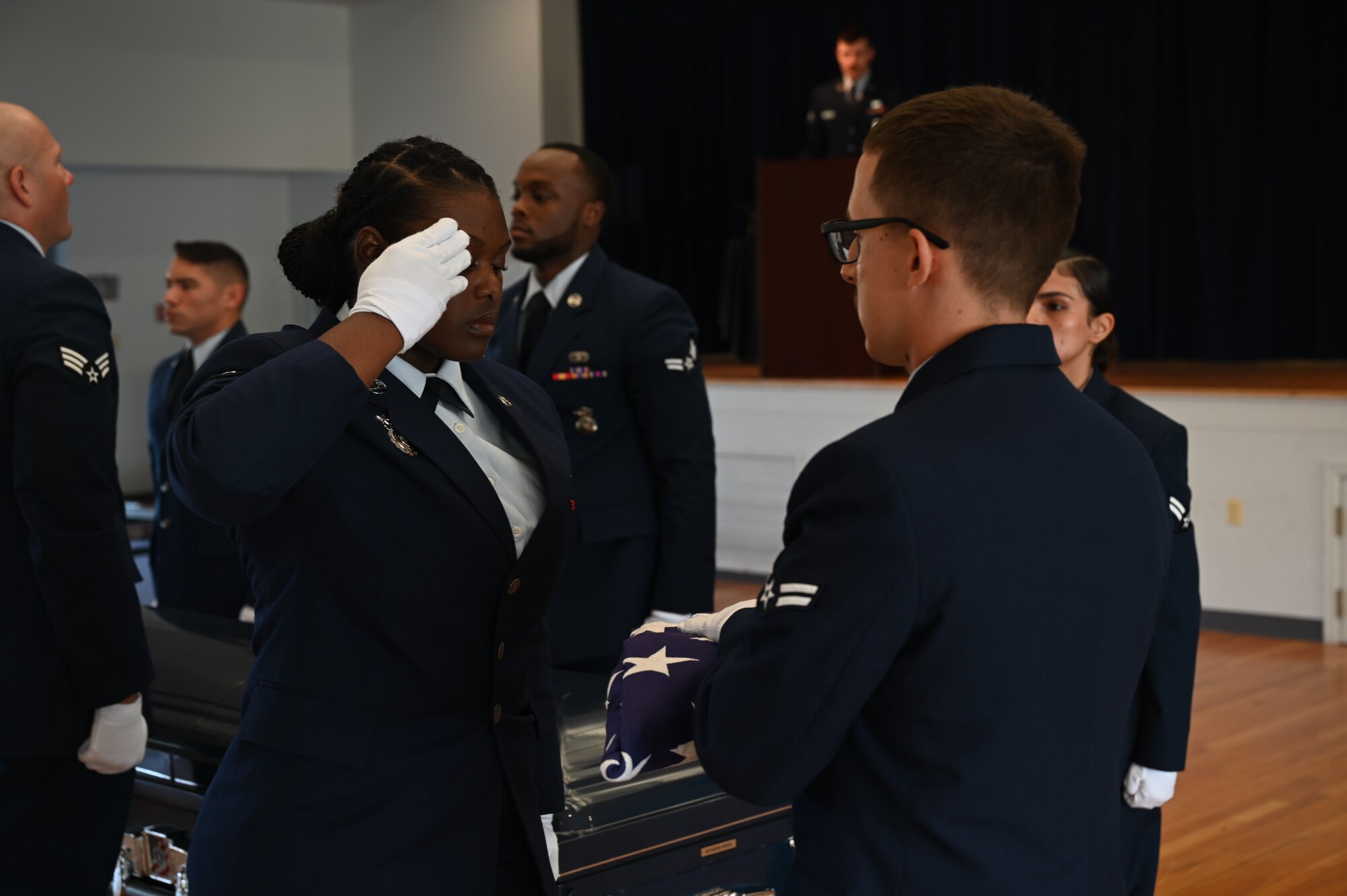 Honor Guard airman graduate saluting Old Glory