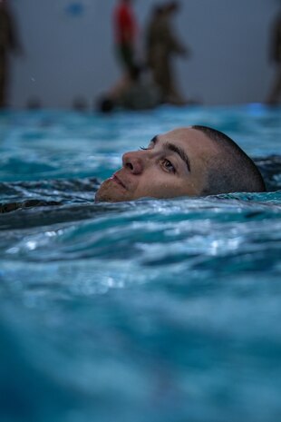 A U.S. Marine Corps recruit with Alpha Company, 1st Recruit Training Battalion, executes a backstroke technique during swim week at Marine Corps Recruit Depot San Diego, Sept. 18, 2023. Basic Swim Qualification teaches recruits essential skills for executing basic water maneuvers and promotes combat readiness among recruits. (U.S. Marine Corps photo by Lance Cpl. Francisco Angel)