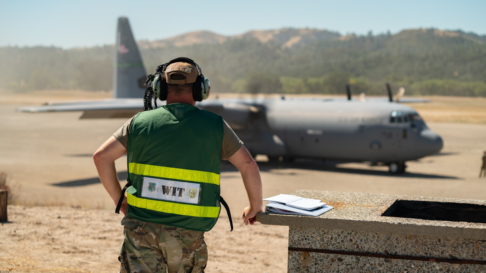 A California Air National Guard C-130J Super Hercules aircraft assigned to the 115th Airlift Squadron prepares to depart on a tactical runway during an exercise at Schoonover Airfield, Fort Hunter Liggett, California, Sept. 9, 2023. The exercise, also known as Crisis Beach II, was a multi-day exercise to evaluate the 146th Airlift Wing's ability to deploy, adapt, and survive in a contested environment. Airmen participating implemented many skill sets shared from other career fields to demonstrate their ability to execute the Agile Combat Employment (ACE) model, highlighting their proactive and reactive operational strategies under simulated threat timelines in order to increase survivability while generating combat power. (U.S. Air National Guard photo by Maj. Andrei Mostovoj)