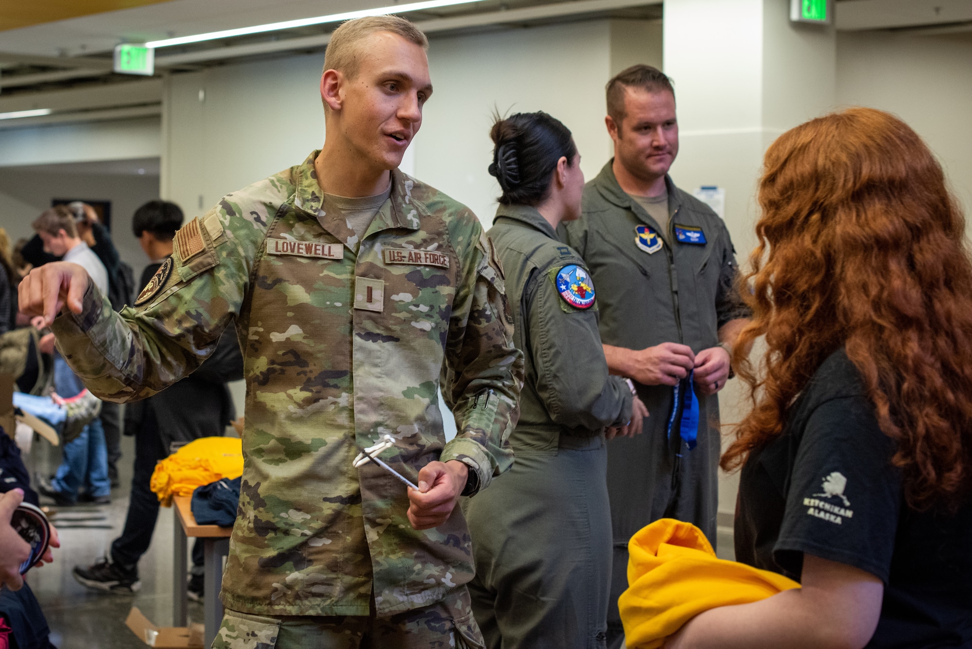 U.S. Air Force 2nd Lt. Nathan Lovewell, Gold Bar recruiter assigned to the 367th Recruiting Squadron, Colorado Springs, Colorado, converses with a student about the Aim High Flight Academy during a recruiting visit to Kodiak High School, in Kodiak, Alaska, Sept. 6, 2023.