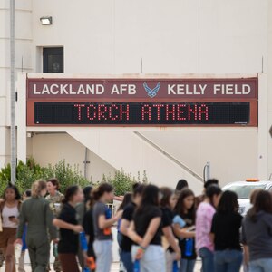 Attendees walk onto the flightline for the Torch Athena Girls in Aviation Day Celebration, Joint Base San Antonio-Lackland Kelly Field, Texas, Sept. 21, 2023. About 400 local students attended the event, which showcased women from across Air Education and Training Command and their aircraft. The women represented various career fields, such as pilots, maintainers and boom operators.