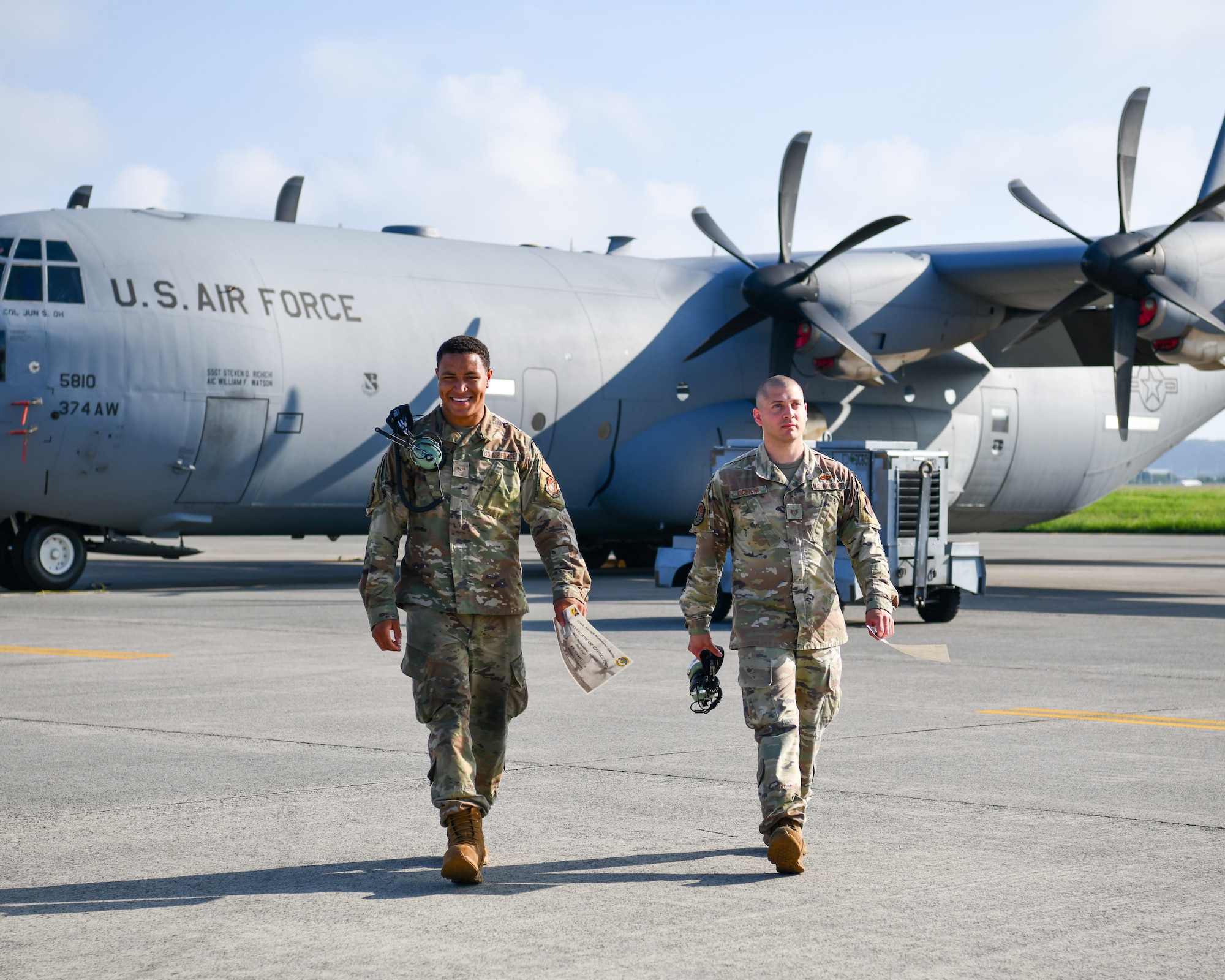 (Left to right) Airman 1st Class William Watson and Staff Sgt. Steven Richichi, 374th Aircraft Maintenance Squadron hydraulic systems specialists, pose in front of a Yokota C-130J Super Hercules after being named Dedicated Crew Chiefs at Yokota Air Base, Japan, Sept. 18, 2023. The Dedicated Crew Chief program is a longstanding military tradition that first began in the Army Air Corps. (U.S. Air Force photo by Staff Sgt. Spencer Tobler)