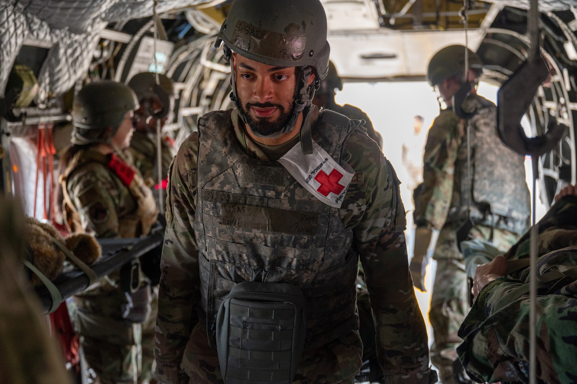 U.S. Air Force Staff Sgt. Roger Ford, 8th Healthcare Operations Squadron manpower manager, carries a medical training mannequin into a U.S. Army CH-47 Chinook while participating in a joint medical evacuation training.