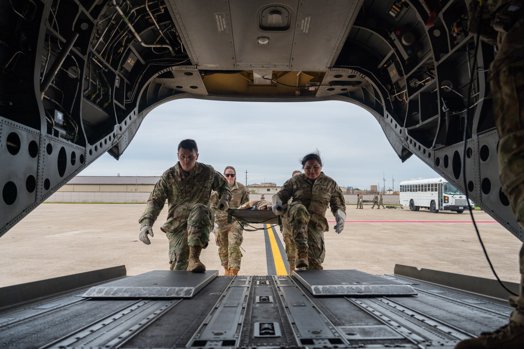 Airmen from the 8th Medical Group carry a medical training mannequin onto a U.S. Army CH-47 Chinook while participating in a joint medical evacuation training.