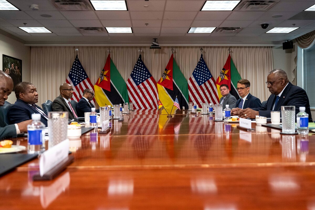 A group of people meet around a large table.