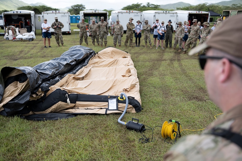 U.S. Airmen assigned to the Kentucky Air National Guard's 123rd Medical Group, Detachment 1, assemble an inflatable tent during a collective training exercise at Camp Santiago Joint Training Center, Salinas, Puerto Rico, Aug. 10, 2023. The exercise allowed service members assigned to the 156th Medical Group, 123rd Medical Group and the Puerto Rico Army National Guard to exchange knowledge and implement the National Guard CBRN Response Enterprise Information Management System, which assists with accelerating data collection from search and extraction teams in emergency events. (U.S. Air National Guard photo by Master Sgt. Rafael D. Rosa)