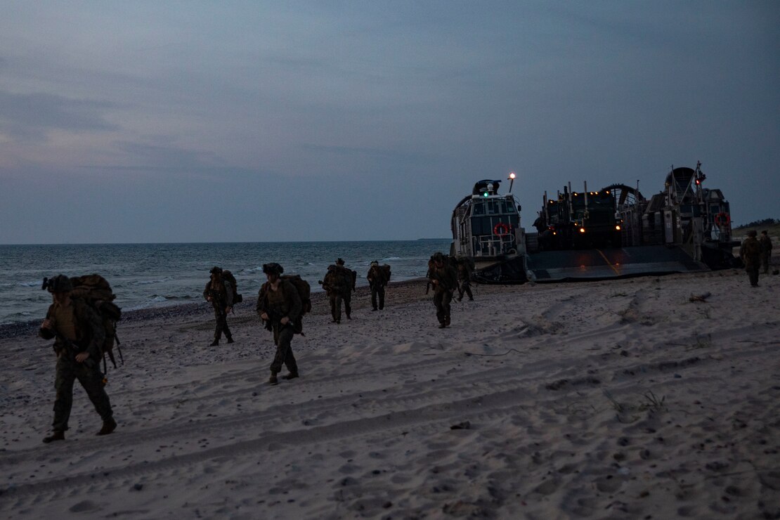 U.S. Marines assigned to Battalion Landing Team 1/6, 26th Marine Expeditionary Unit (Special Operations Capable) (26MEU(SOC)), disembark from a landing craft, air cushion to begin a patrol during an amphibious landing for Northern Coast 2023 (NOCO 23) in Ventspils, Latvia, Sept. 12, 2023. NOCO 23 is a German-led multinational exercise that strengthens military and maritime combat readiness through realistic training in order to sharpen interoperability with our Allies and partners. The San Antonio-class amphibious ship USS Mesa Verde (LPD 19), assigned to the Bataan Amphibious Ready Group and embarked 26MEU(SOC), under the command and control of Task Force 61/2, is on a scheduled deployment in the U.S. Naval Forces Europe area of operations, employed by U.S. Sixth Fleet to defend U.S., allied, and partner interests. (U.S. Marine Corps photo by Staff Sgt. Jesus Sepulveda Torres)