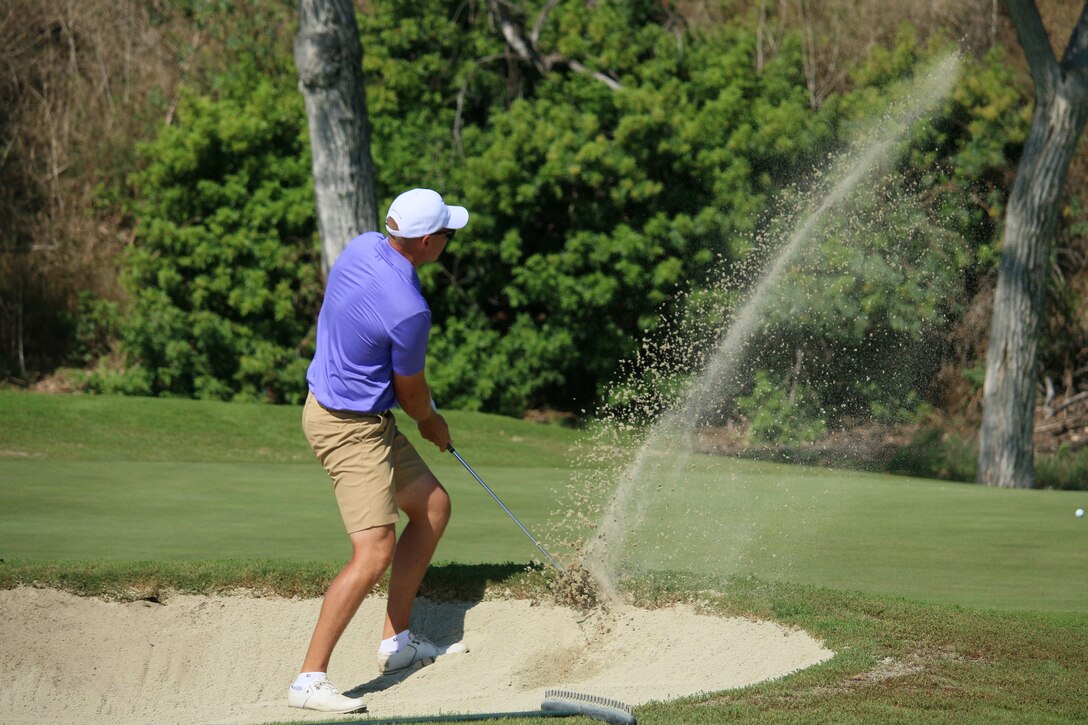 Marine Capt. Nicholas Brediger here in the bunker, holds on to his lead for the men by 2 strokes while the Air Force men continue to lead the in the men's team competition.  2023 marks the 75th anniversary of Armed Forces Golf. This year, Naval Base San Diego hosts the championship at the Admiral Baker Golf Course, featuring teams from the Army, Marine Corps, Navy, and Air Force (with Space Force players); and for the first time as a stand alone team, the U.S. Coast Guard.  Department of Defense Photo by Mr. Steven Dinote - Released.