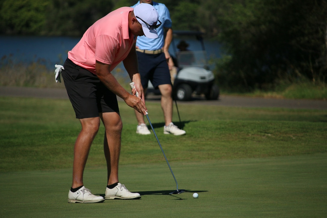 Marine Corps Capt. Nicholas Brediger of Charlottesville, Virginia finishes his last put of his gold medal perform during the Armed Forces Golf Championship. 2023 marks the 75th anniversary of Armed Forces Golf. This year, Naval Base San Diego hosts the championship at the Admiral Baker Golf Course, featuring teams from the Army, Marine Corps, Navy, and Air Force (with Space Force players); and for the first time as a stand alone team, the U.S. Coast Guard.  Department of Defense Photo by Mr. Steven Dinote - Released.