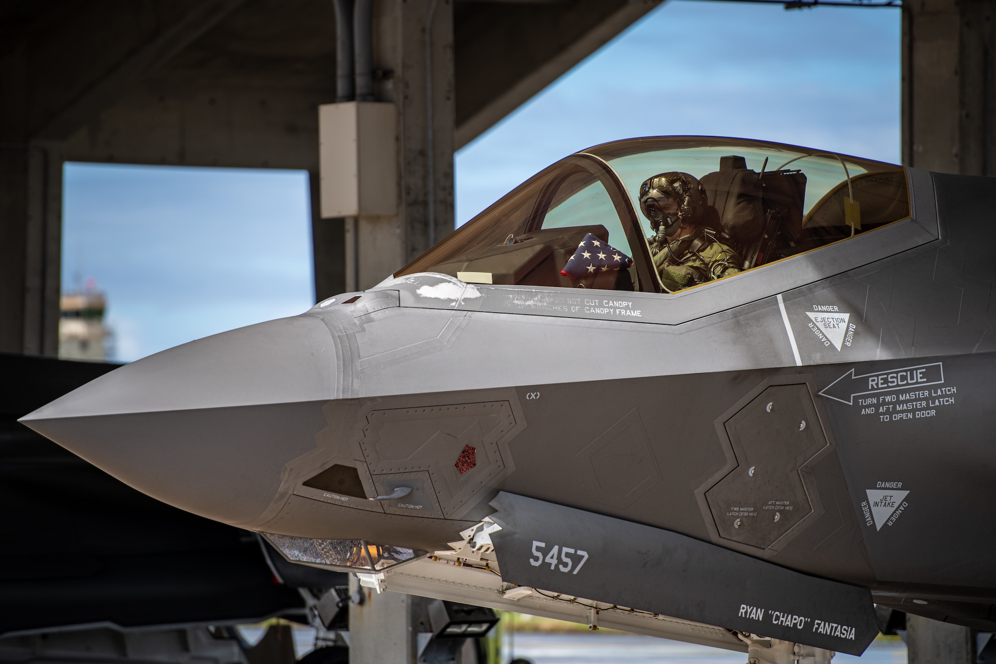 A pilot sits in an F-35 fighter jet