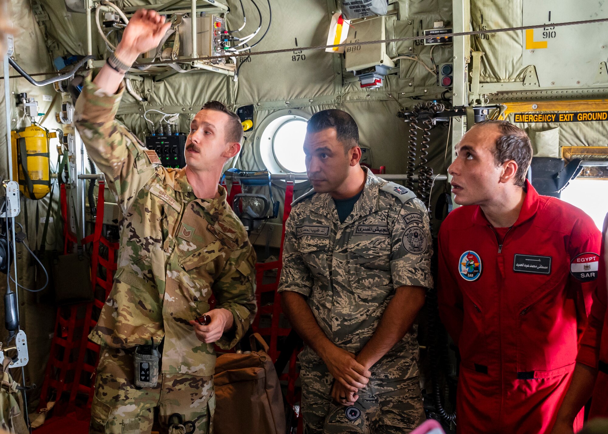 U.S. Air Force Tech. Sgt. Bobby Goldsby, Aeromedical Evacuation Technician, assigned to the 405th Expeditionary Aeromedical Evacuation Squadron at the 386th Air Expeditionary Wing, speaks with Egyptian military members onboard a C-130J Super Hercules in Egypt in support of exercise Bright Star 23, Sept. 10, 2023.