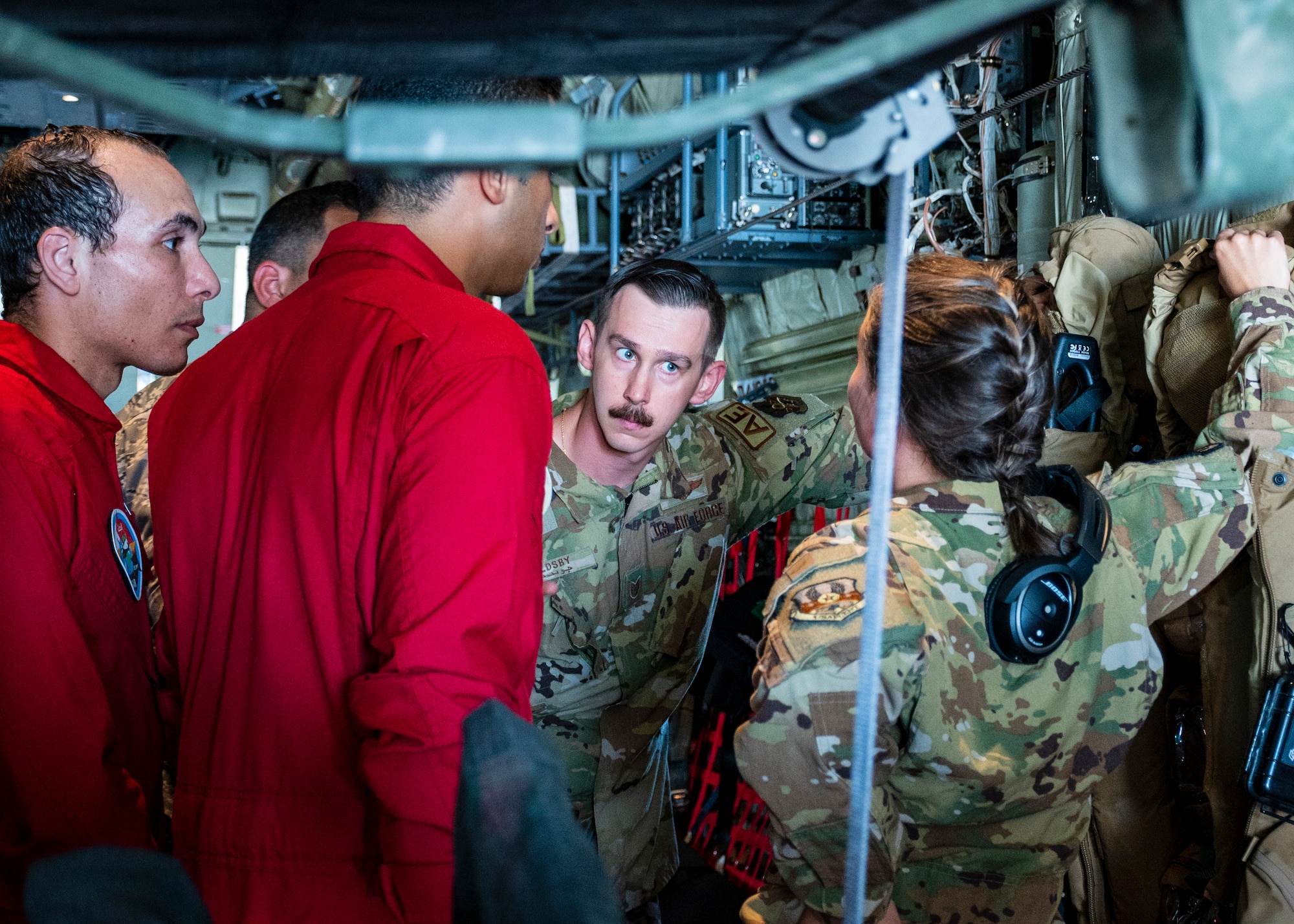 U.S. Air Force Tech. Sgt. Bobby Goldsby, Aeromedical Evacuation Technician, and Capt. Courtney Shockley, Flight Nurse, assigned to the 405th Expeditionary Aeromedical Evacuation Squadron at the 386th Air Expeditionary Wing, speak with Egyptian military members onboard a C-130J Super Hercules in Egypt in support of exercise Bright Star 23, Sept. 10, 2023.