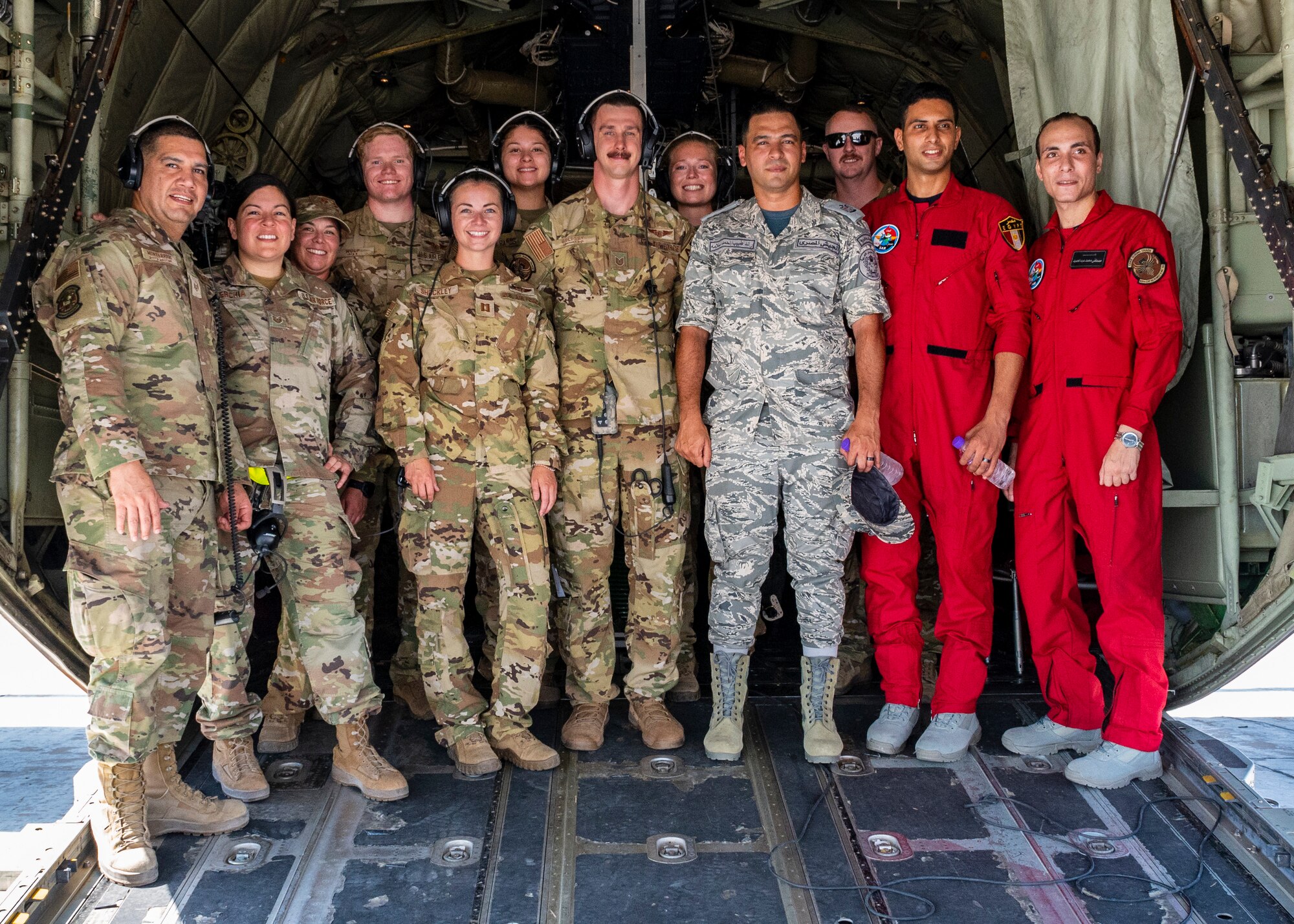 U.S. Air Force service members assigned to the 405th Expeditionary Aeromedical Evacuation Squadron and the 61st Expeditionary Airlift Squadron, assigned to the 386th Air Expeditionary Wing, stand for a photo with Egyptian military members on a C-130J Super Hercules while executing exercise Bright Star 23, Sept. 10, 2023.