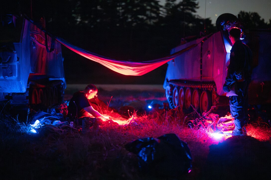 Soldiers rest during a training exercise at night.