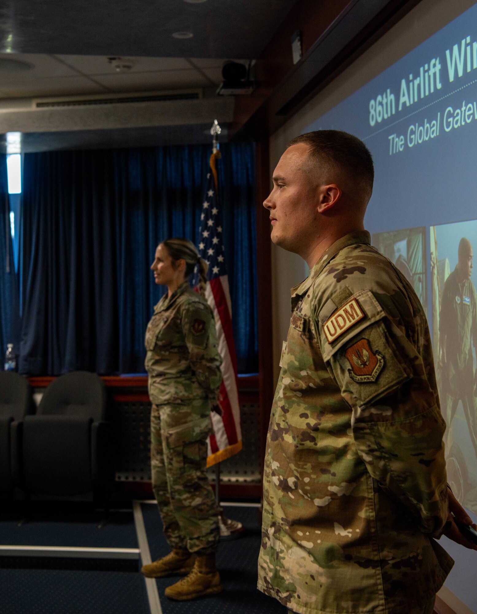 Airmen stand for briefing.