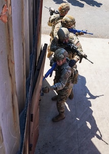 U.S. Air National Guard Airmen assigned to the 146th Security Forces Squadron and Emergency Management Airmen, assigned to the 146th Civil Engineer Squadron stack up in formation before entering a building in an integrated exercise at the Oxnard College Fire Academy and the Ventura County Fire Department training center, Camarillo, California, Sept. 8-9, 2023.