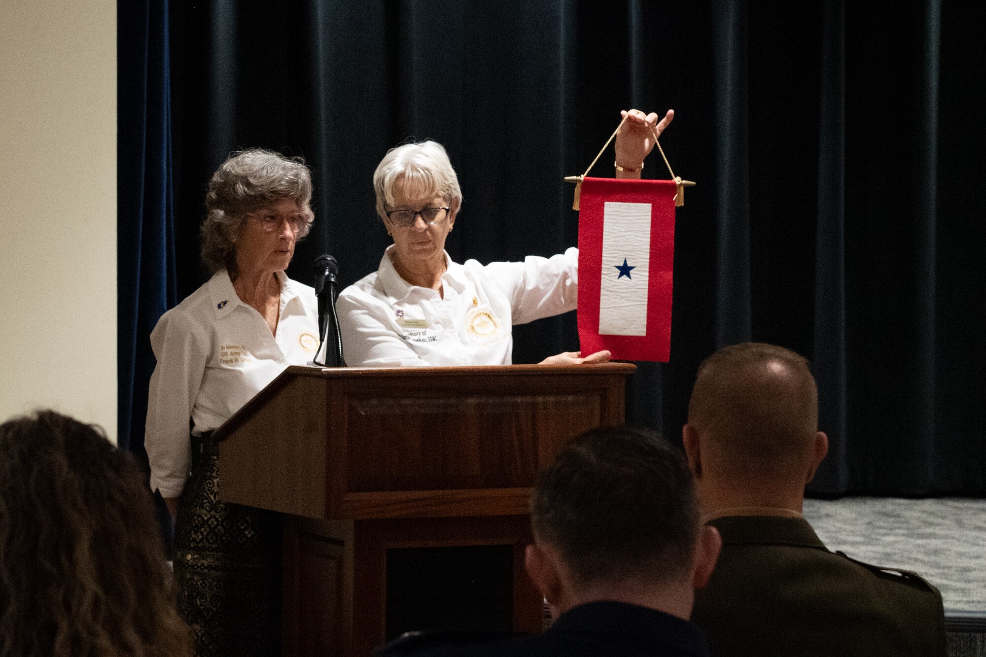 Michele Carey, Gold Star Mother of USMC Corporal Barton Humlhanz, and Toni Gross, Gold Star Mother of U.S. Army Corporal Frank R. Gross, present the symbols of service and sacrifice during the Gold Star Mothers and Families Day at MacDill Air Force Base, Florida, Sept. 24, 2023.