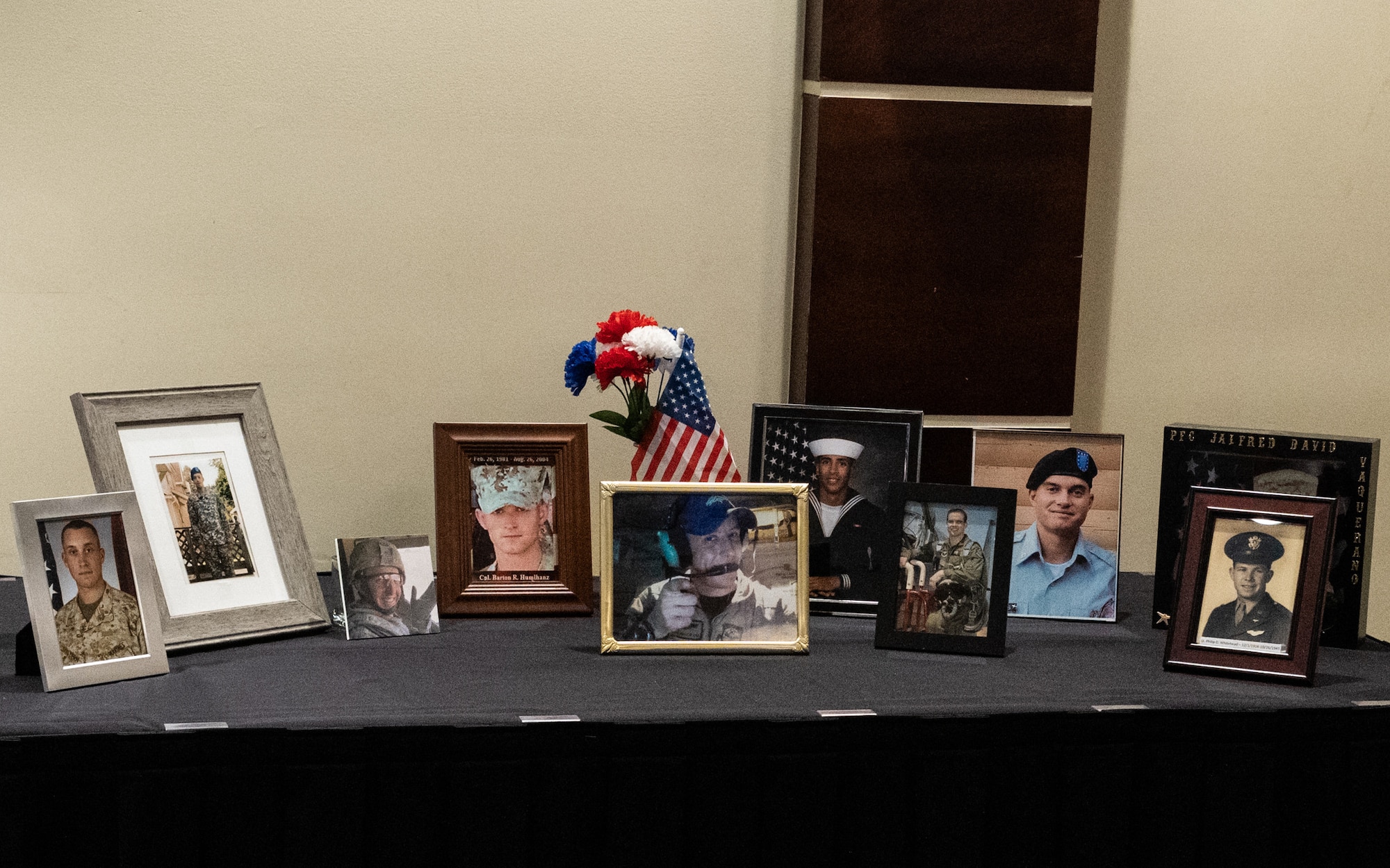 Pictures of fallen military members are displayed on a table during a ceremony for Gold Star Mothers and Families Day at MacDill Air Force Base, Florida, Sept. 24, 2023.