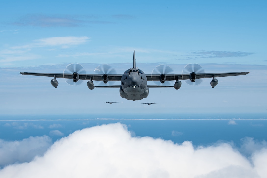 Three aircraft fly toward the camera during daylight with clouds beneath and behind them.