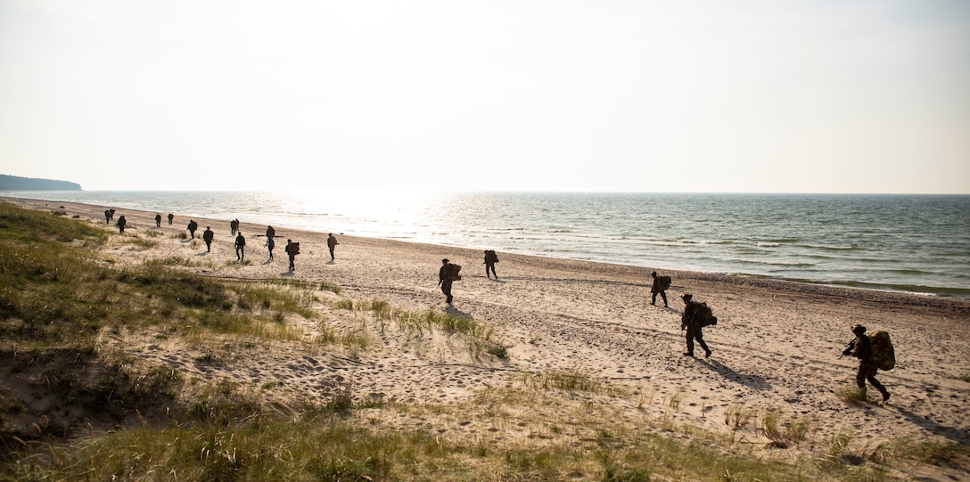 Italian Marines San Marco Brigade begin a patrol towards their objective while being supported by U.S. Marines with the Battalion Landing Team 1/6, 26th Marine Expeditionary Unit (26MEU(SOC)) during an amphibious landing for Northern Coast 2023 in Ventspils, Latvia, Sept. 12, 2023. NOCO 23 is a German-led multinational exercise that strengthens military and maritime combat readiness through realistic training in order to sharpen interoperability with our Allies and partners. The San Antonio-class amphibious ship USS Mesa Verde, assigned to the Bataan Amphibious Ready Group and embarked 26MEU(SOC), under the command and control of Task Force 61/2, is on a scheduled deployment in the U.S. Naval Forces Europe area of operations, employed by U.S. Sixth Fleet to defend U.S., allied, and partner interests.
