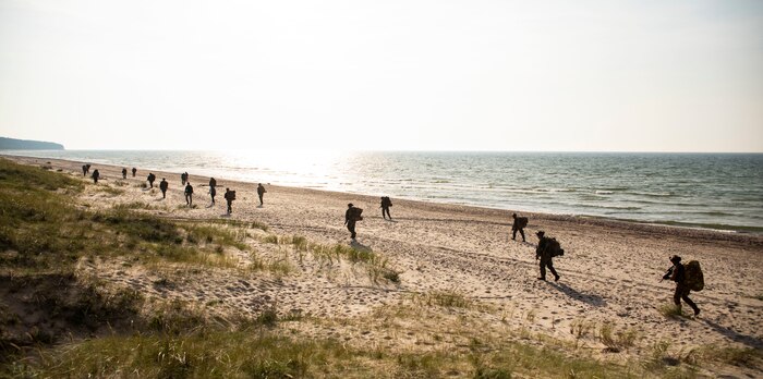 Italian Marines San Marco Brigade begin a patrol towards their objective while being supported by U.S. Marines with the Battalion Landing Team 1/6, 26th Marine Expeditionary Unit (26MEU(SOC)) during an amphibious landing for Northern Coast 2023 in Ventspils, Latvia, Sept. 12, 2023. NOCO 23 is a German-led multinational exercise that strengthens military and maritime combat readiness through realistic training in order to sharpen interoperability with our Allies and partners. The San Antonio-class amphibious ship USS Mesa Verde, assigned to the Bataan Amphibious Ready Group and embarked 26MEU(SOC), under the command and control of Task Force 61/2, is on a scheduled deployment in the U.S. Naval Forces Europe area of operations, employed by U.S. Sixth Fleet to defend U.S., allied, and partner interests.