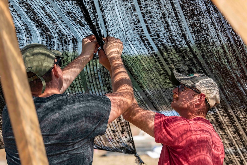 Men erect netting.