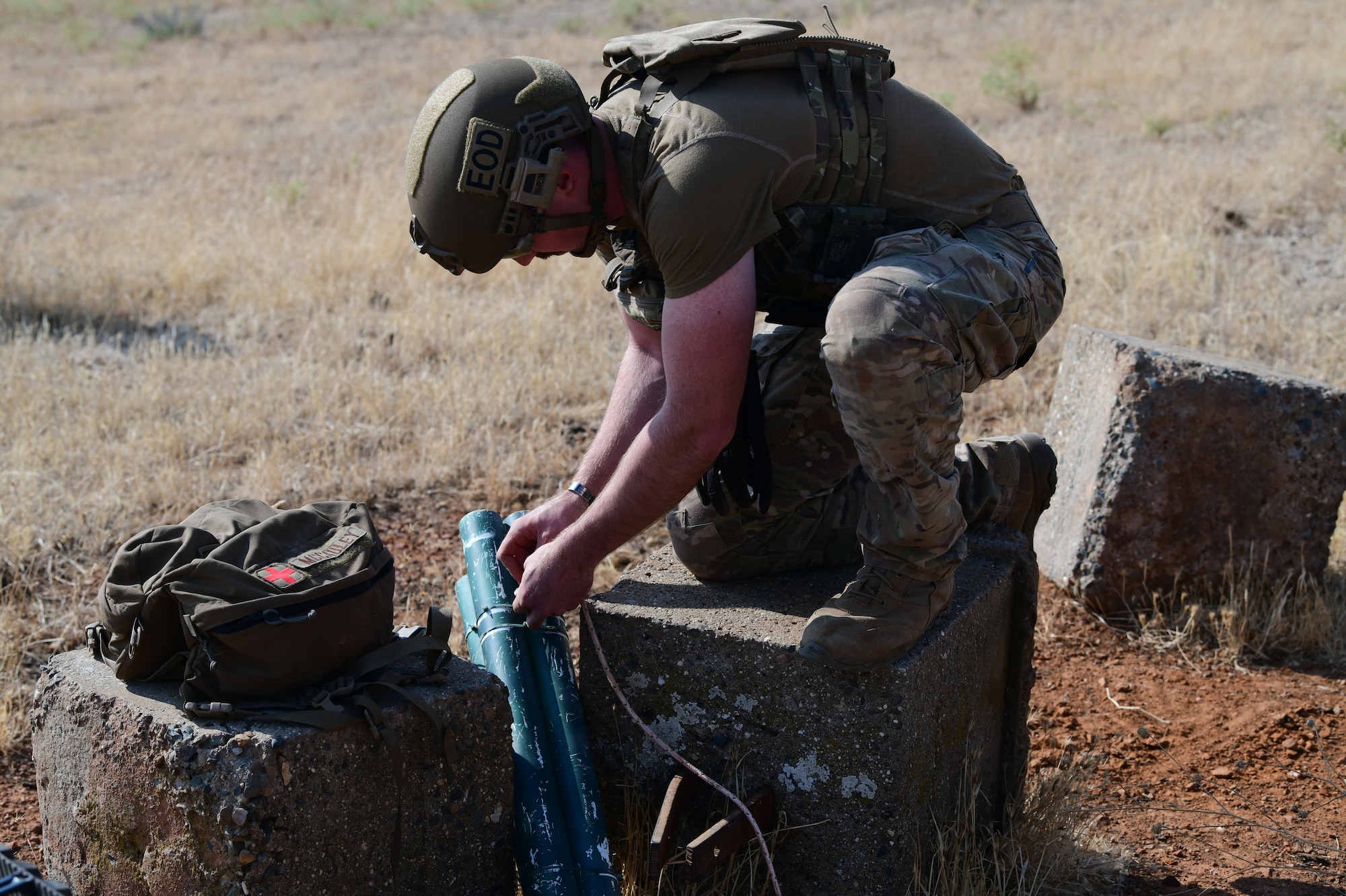 U.S. Air Force Staff Sgt. Jonathan McCauley, 9th Civil Engineer Squadron explosive ordnance disposal (EOD) team member, ties rope around an improvised rocket during Exercise GOLDEN CRAB on Beale Air Force Base (AFB), California, Sept. 20, 2023.