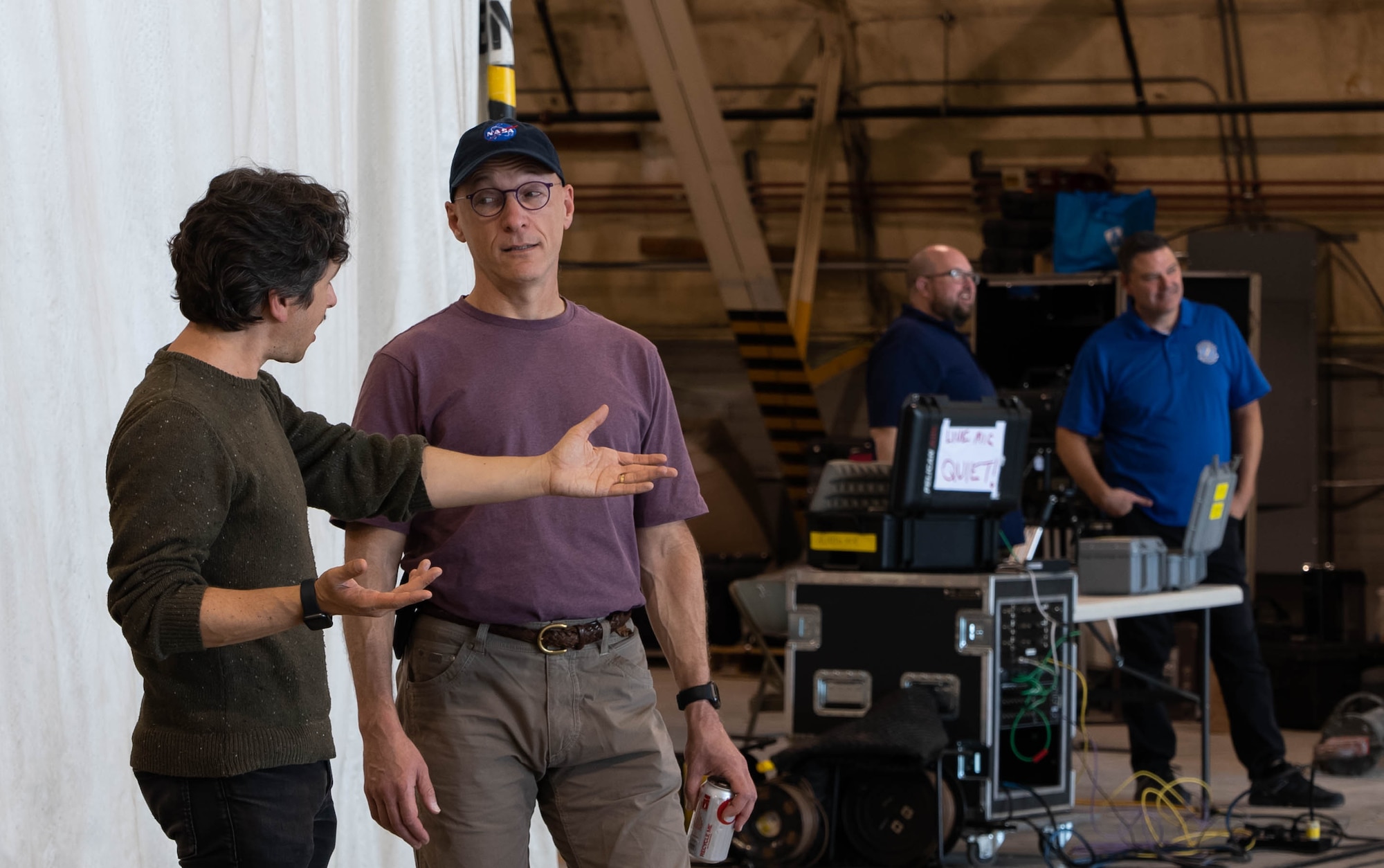 Two men discuss options in an aircraft hangar