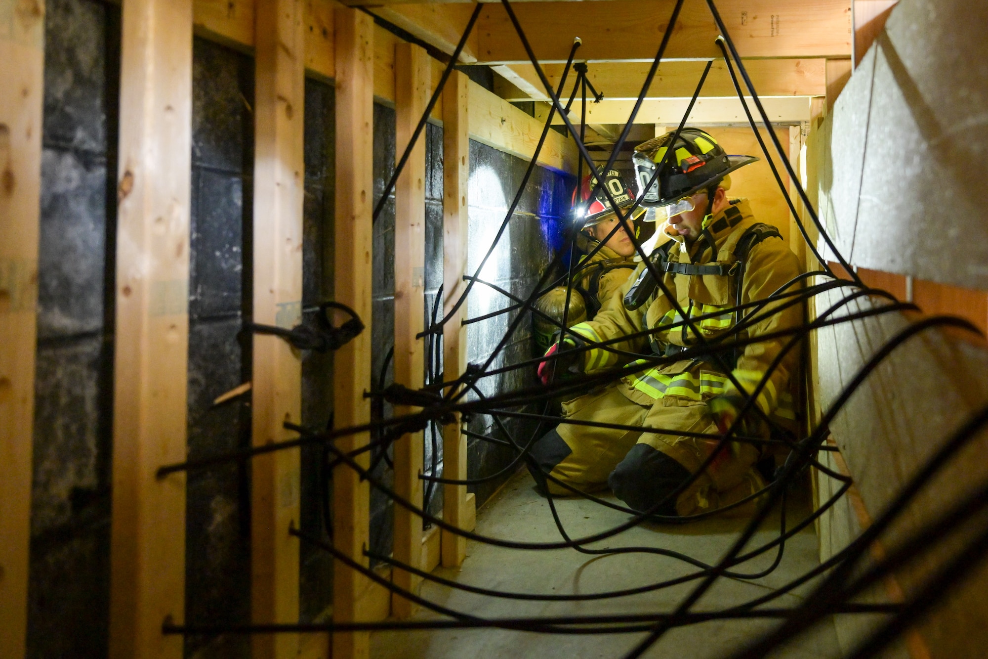 Anthony Mason, a Youngstown Air Reserve Station firefighter, explains to Col. Greg Meyer, 910th Mission Support Group commander, how to navigate a portion of a confined spaces obstacle course at YARS, Ohio, Sept. 21, 2023.
