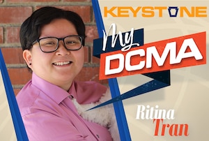 A woman poses for a photo framed with a graphic saying "Keystone MyDCMA Ritina Tran"