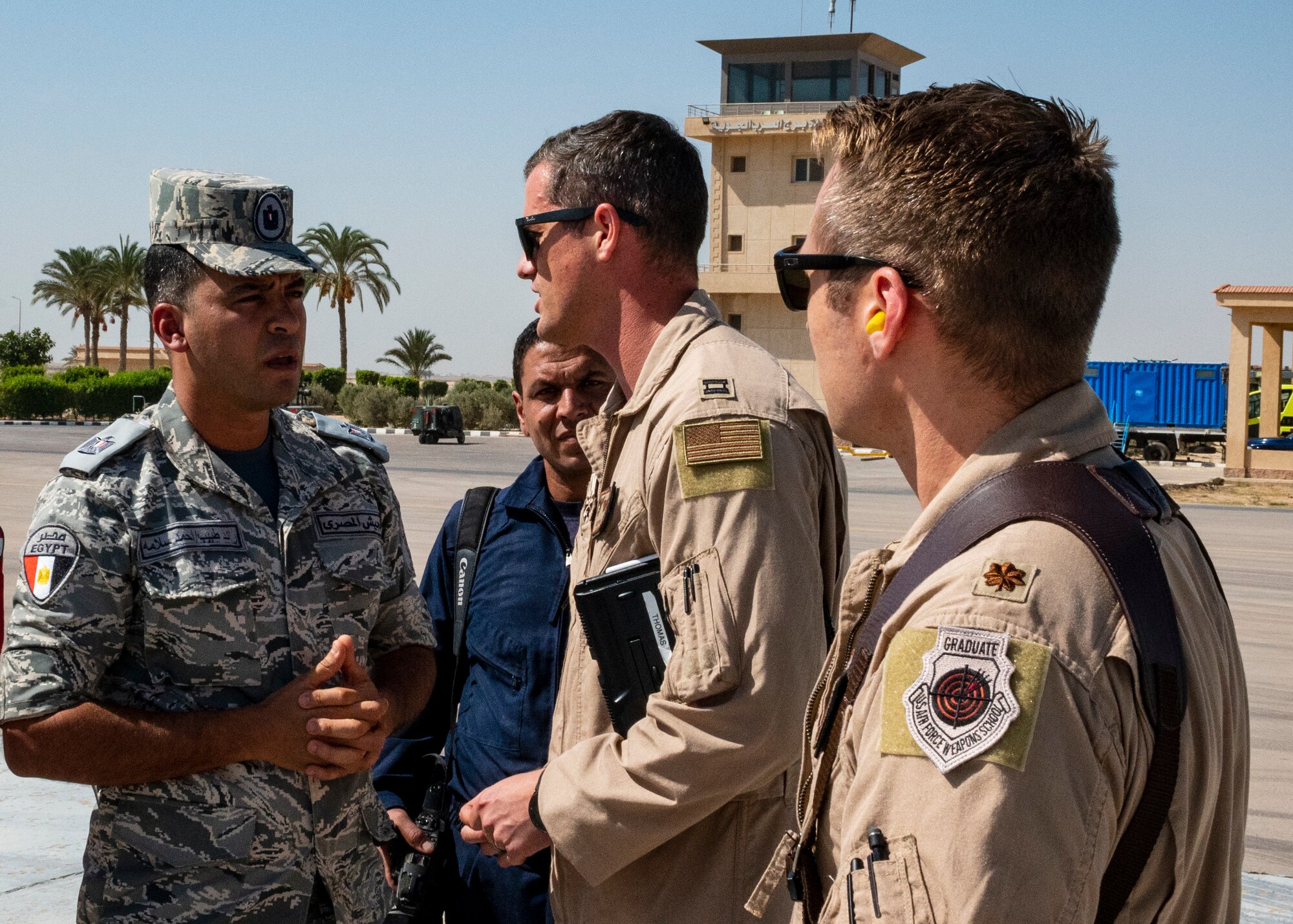 U.S. Air Force pilots assigned to the 61st Expeditionary Airlift Squadron at the 386th Air Expeditionary Wing speak with Egyptian military members on a flight line in Egypt in support of exercise Bright Star 23, Sept. 10, 2023.