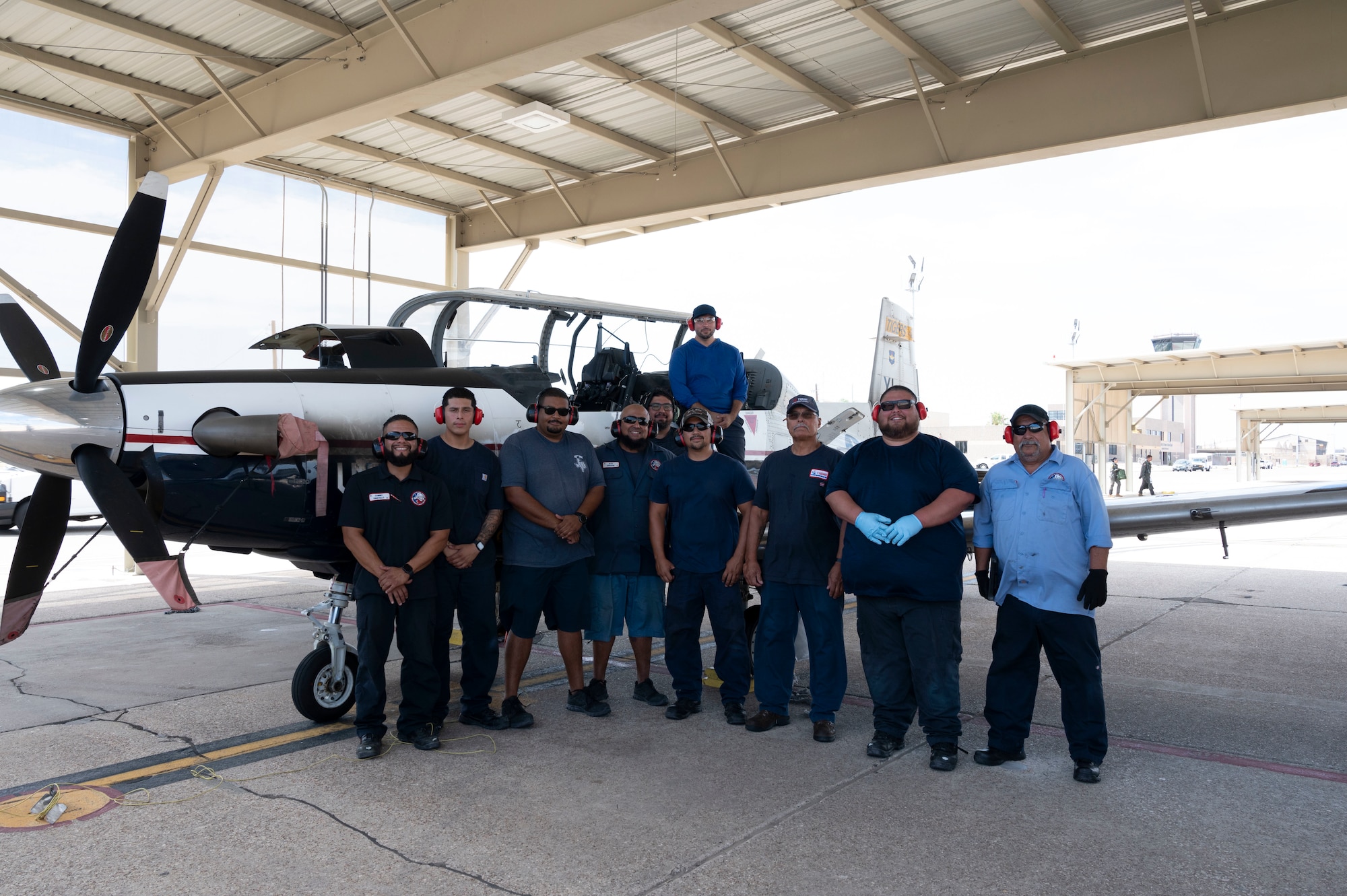 47th Maintenance Directorate aircraft attendants pose in front of a T-6A Texan II on the flight line at Laughlin Air Force Base, Texas, Sept. 11, 2023. In honor of Hispanic Heritage Month, these MXD workers were highlighted for their impact on Laughlin’s mission of producing the world’s best pilots. (U.S. Air Force photo by Airman 1st Class Kailee Reynolds)