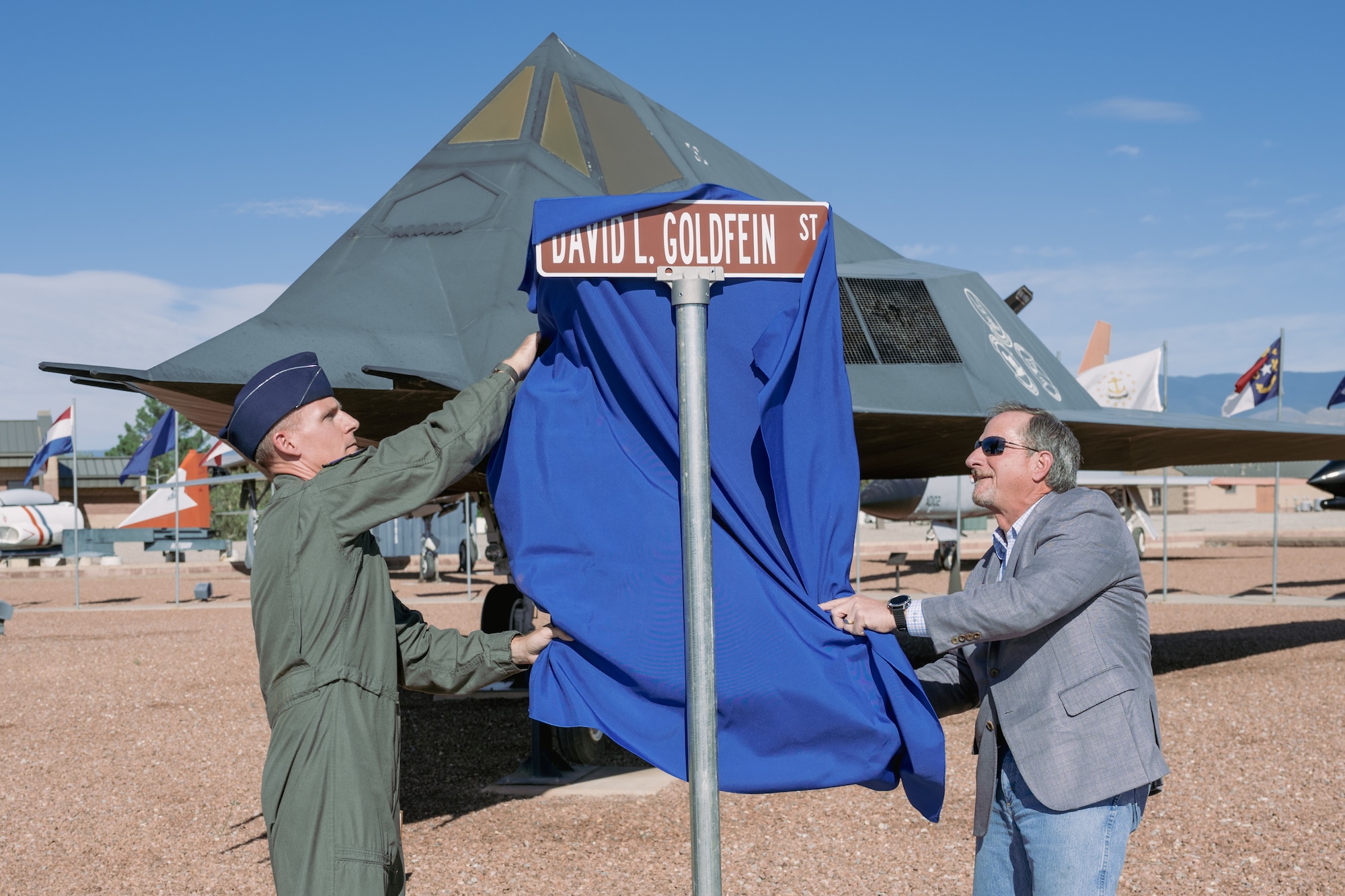 Retired U.S. Air Force Gen. David L. Goldfein, right, and U.S. Air Force Col. Justin Spears, 49th Wing commander, unveil a new street sign at Holloman Air Force Base, New Mexico, Sept. 22, 2023. Goldfein took command of the 49th Fighter Wing in 2006, where he served the men and women of Holloman before he continued on to serve as chief of staff of the Air Force. (U.S. Air Force photo by Senior Airman Antonio Salfran)