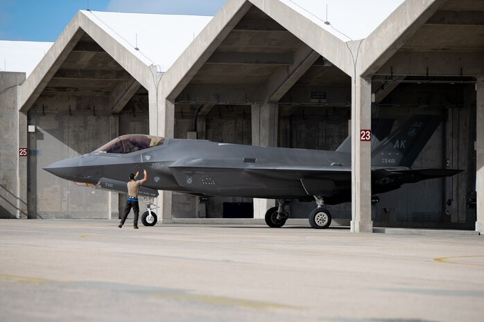 An F-35A Lightning II assigned to the 355th Fighter Squadron is marshaled onto the taxiway during a no-notice fighter dispersal exercise at Kadena Air Base, Japan, Sept. 22, 2023. The exercise showcased the rapid-response capabilities of Airmen across the spectrum of operational, maintenance and support specializations. (U.S. Air Force photo by Staff Sgt. Jessi Roth)