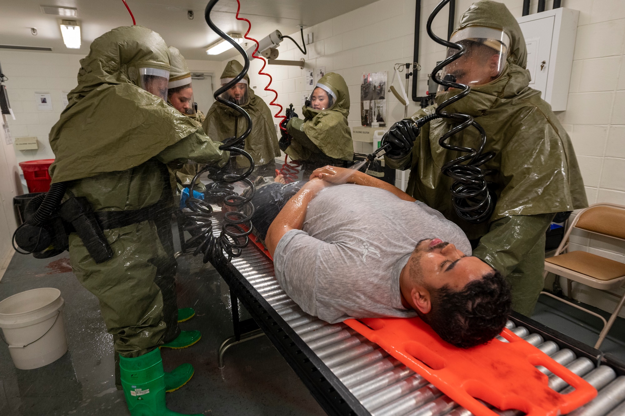 U.S. Air Force Airmen from the 51st Medical Group decontaminate a simulated patient during a mass casualty training event at Osan Air Base, Republic of Korea, Sept. 21, 2023. MASCAL responses introduce a high pressure situation to stress the capabilities of current medical operations. Through routine training, personnel learn how to remain calm and focused under extreme stress, which is crucial for effective decision-making and executing mission objectives. (U.S. Air Force photo by Senior Airman Aaron Edwards)