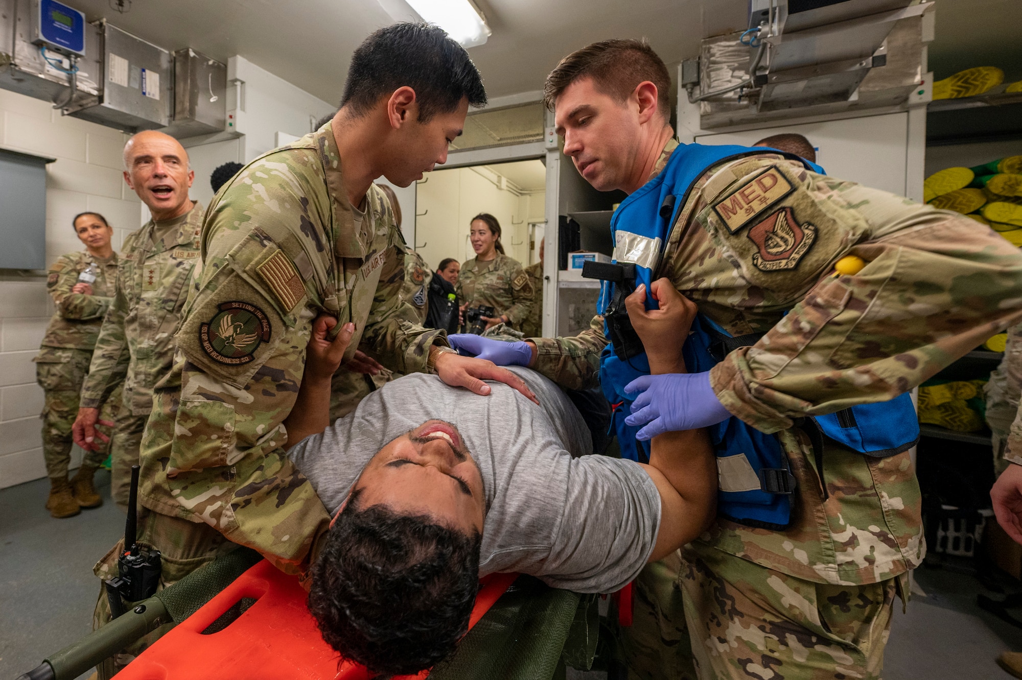 U.S. Air Force Capts. Kevin Wang, left, and Troy Thayer, 51st Operational Medical Readiness Squadron dentists, restrain a simulated patient during a mass casualty training event at Osan Air Base, Republic of Korea, Sept. 21, 2023. The installation-wide training event promoted collaboration and teamwork amongst the 51st Fighter Wing’s different units and agencies, testing their ability to unify operations, execute the mission and foster a seamless response to a complex and high-stress situation. (U.S. Air Force photo by Senior Airman Aaron Edwards)