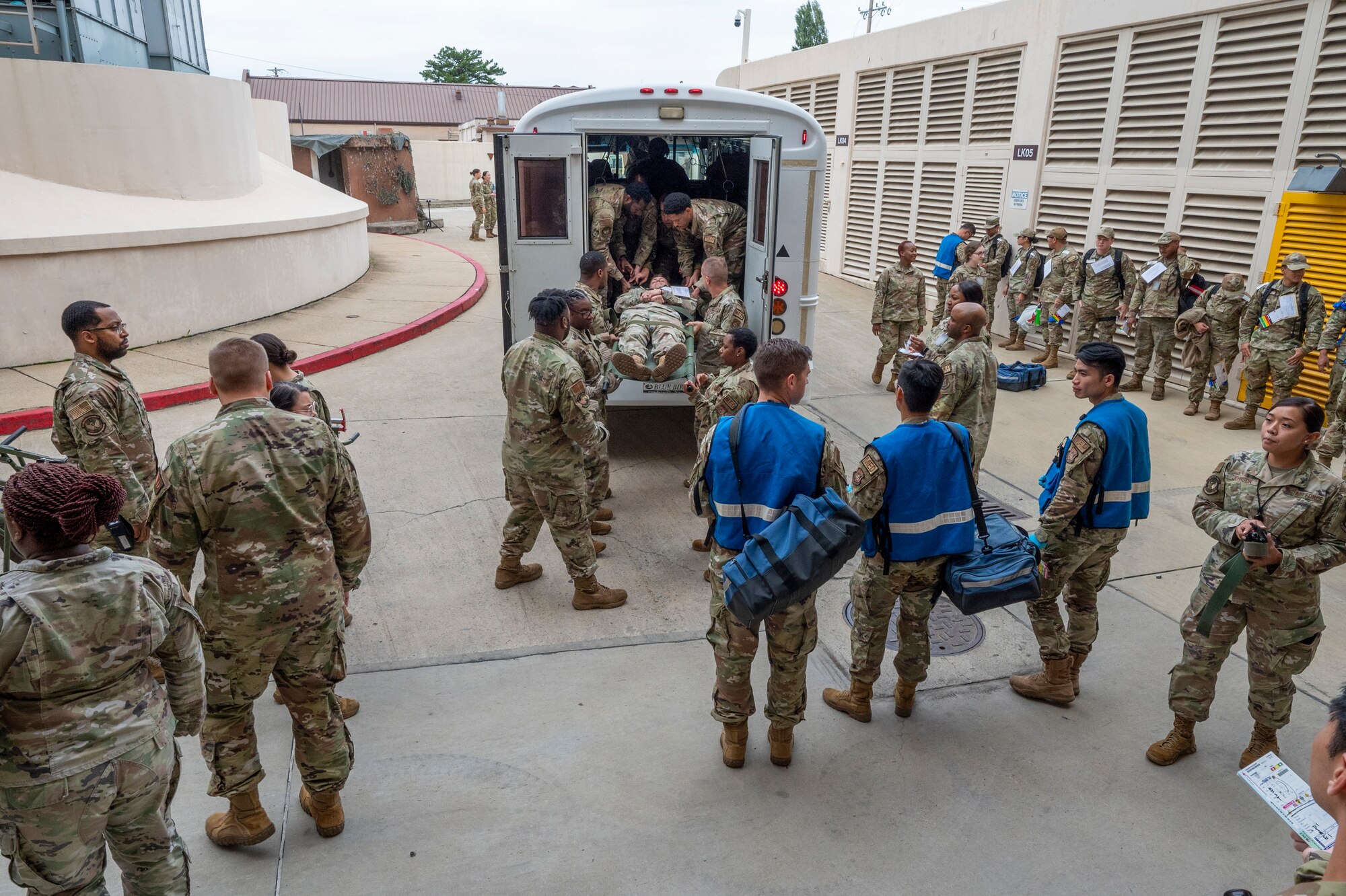 U.S. Air Force Airmen from the 51st Medical Group unload simulated patients from the back of an ambulance during a mass casualty training event at Osan Air Base, Republic of Korea, Sept. 21, 2023. The training event tested Airmen’s ability to execute the MDG’s readiness mission by quickly transporting patients from the field to the urgent care facility. (U.S. Air Force photo by Senior Airman Aaron Edwards) (This photo has been altered for security purposes by blurring out identification badges.)