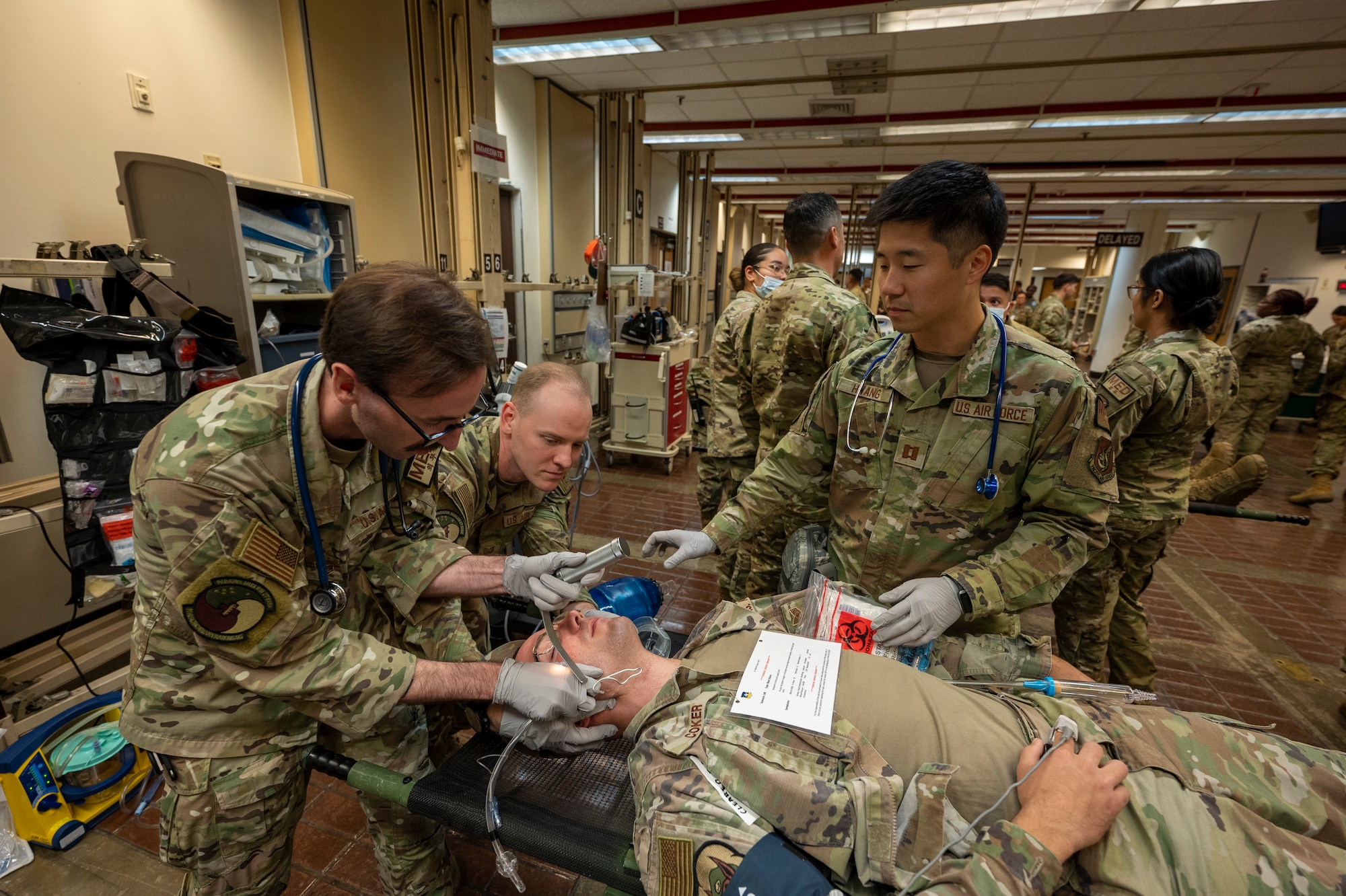 From the Left, U.S. Air Force Staff Sgt. Kyle Roberts, Paramedic; Tech. Sgt. Cody Polen, urgent care noncommissioned officer in charge; and Capt. Alexander Hwang, emergency physician, all from the 51st Healthcare Operations Squadron, intubate a simulated patient during a mass casualty training event at Osan Air Base, Republic of Korea, Sept. 21, 2023. Simulating real-world scenarios through high-stress, complex trainings ensure 51st Fighter Wing personnel are always prepared for real-world emergencies, allowing them to respond swiftly and effectively to save lives during actual crises. (U.S. Air Force photo by Senior Airman Aaron Edwards)