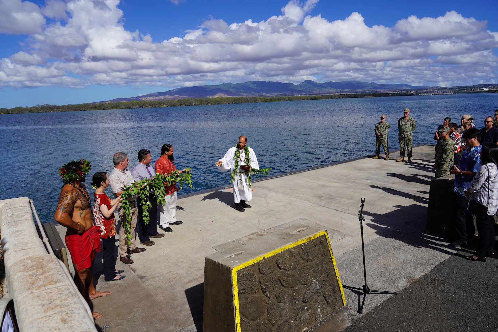 Kahu Kordell Kekoa, center, a Hawaiian priest, performs a traditional Hawaiian oli (chant) to bless the land, asking for protection and to foster good energy, during a Hawaiian blessing ceremony held at the water front of Pearl Harbor.