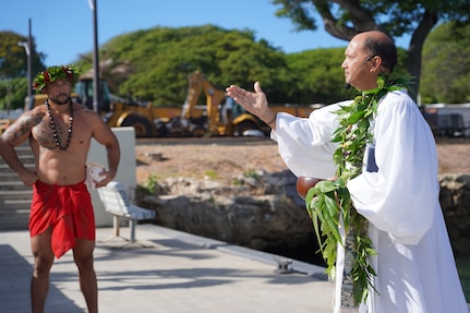 Kahu Kordell Kekoa, right, a Hawaiian priest, performs a traditional Hawaiian oli (chant) to bless the land, asking for protection and to foster good energy, during a Hawaiian blessing ceremony held at the water front of Pearl Harbor.