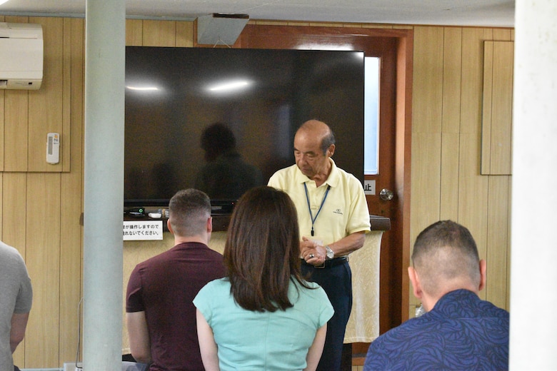 “Greg” Kouta pauses during his talks with members from the Combined Arms Training Center during their visit of the historical Japanese memorial Mikasa warship.