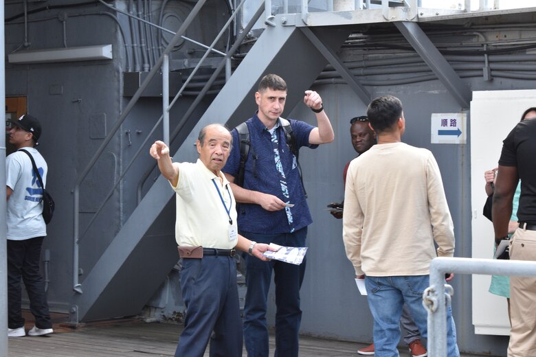“Greg” Kouta makes suggestions about where Major Brad Hull and others can begin their tour of the historical Japanese memorial Mikasa warship.