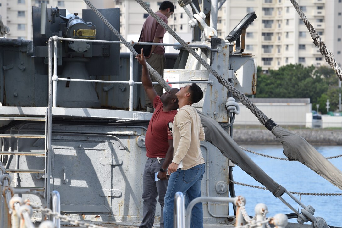 Gunnery Sgt. Sonlord Jean and Staff Sgt. Fernando Quijano examine exterior structures during their visit of the historical Japanese memorial Mikasa warship.