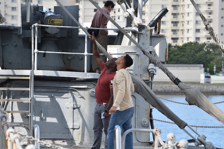 Gunnery Sgt. Sonlord Jean and Staff Sgt. Fernando Quijano examine exterior structures during their visit of the historical Japanese memorial Mikasa warship.